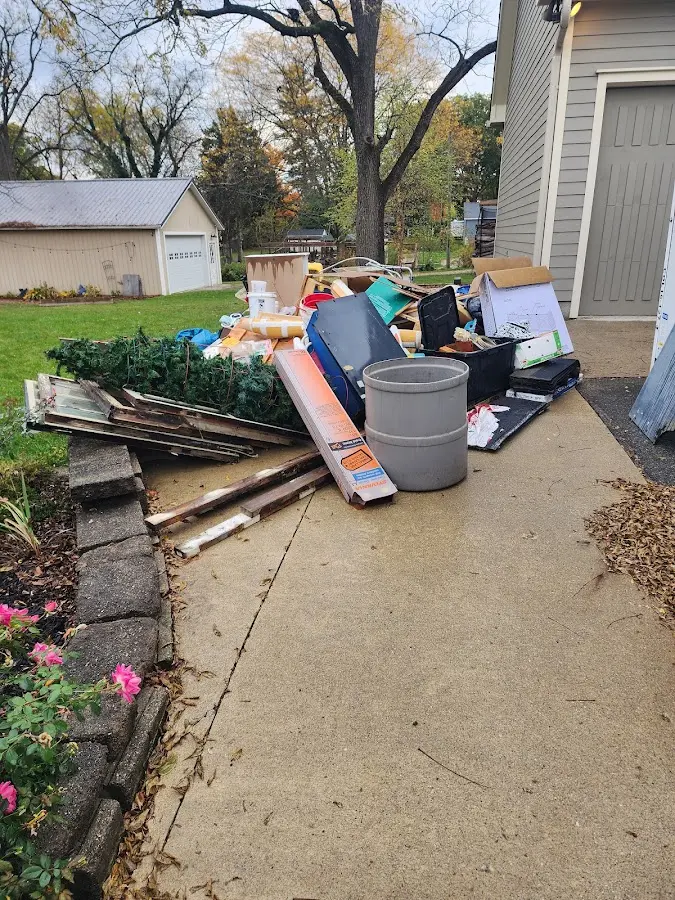 Dumpster being loaded with debris for Estate Cleanout Dumpster Rental in South Apopka